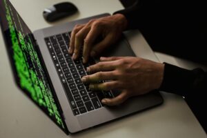 crop-cyber-spy-hacking-system-while-typing-on-laptop