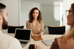 Woman presenting to colleagues in a meeting room during onboarding