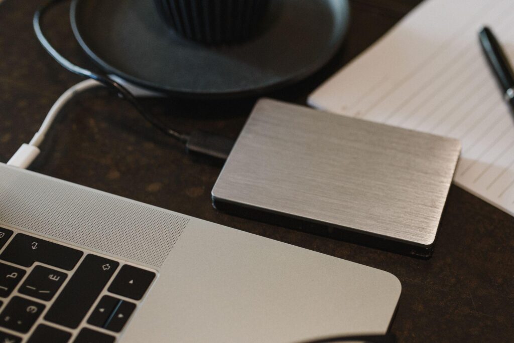 External hard drive next to a laptop, representing a data backup