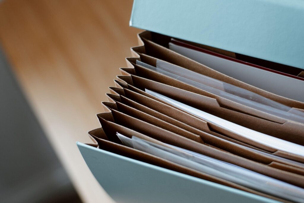 Box of filed paper documents and folders